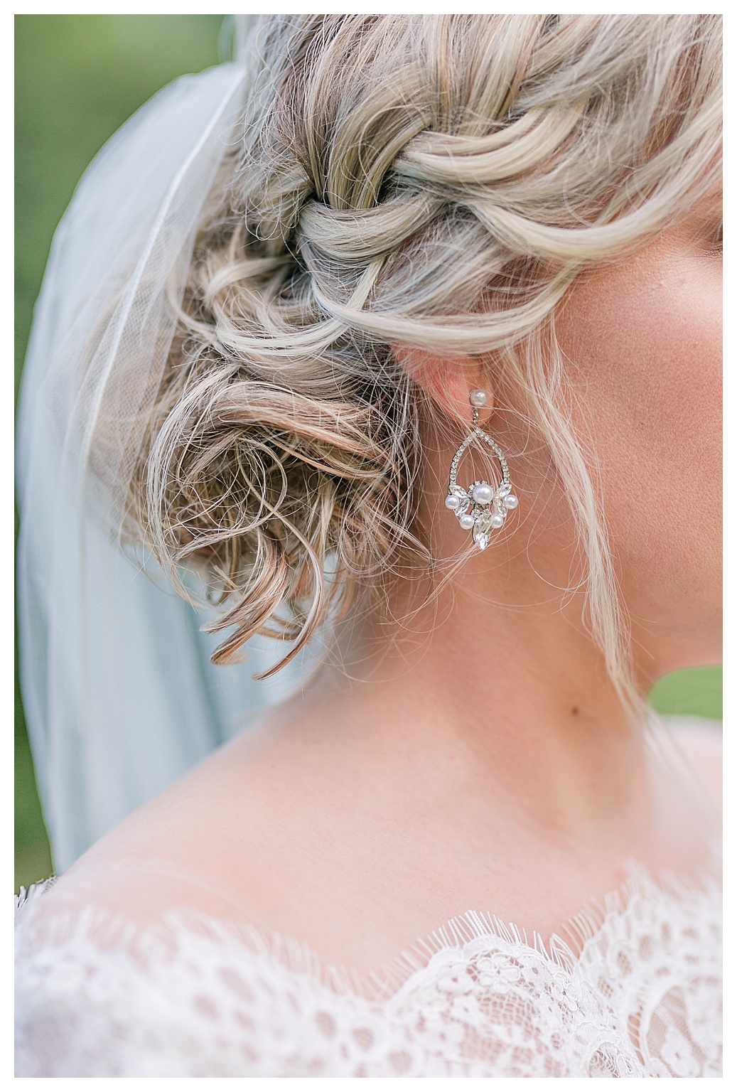 closeup of bride's earrings and curled hair