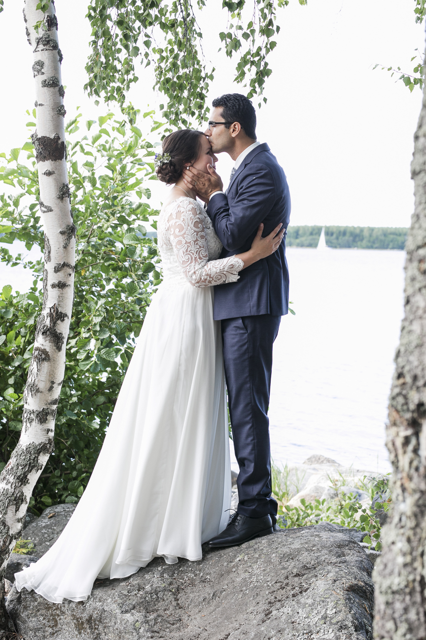 Bride and groom kissing on the coast of Vaasa, Finland