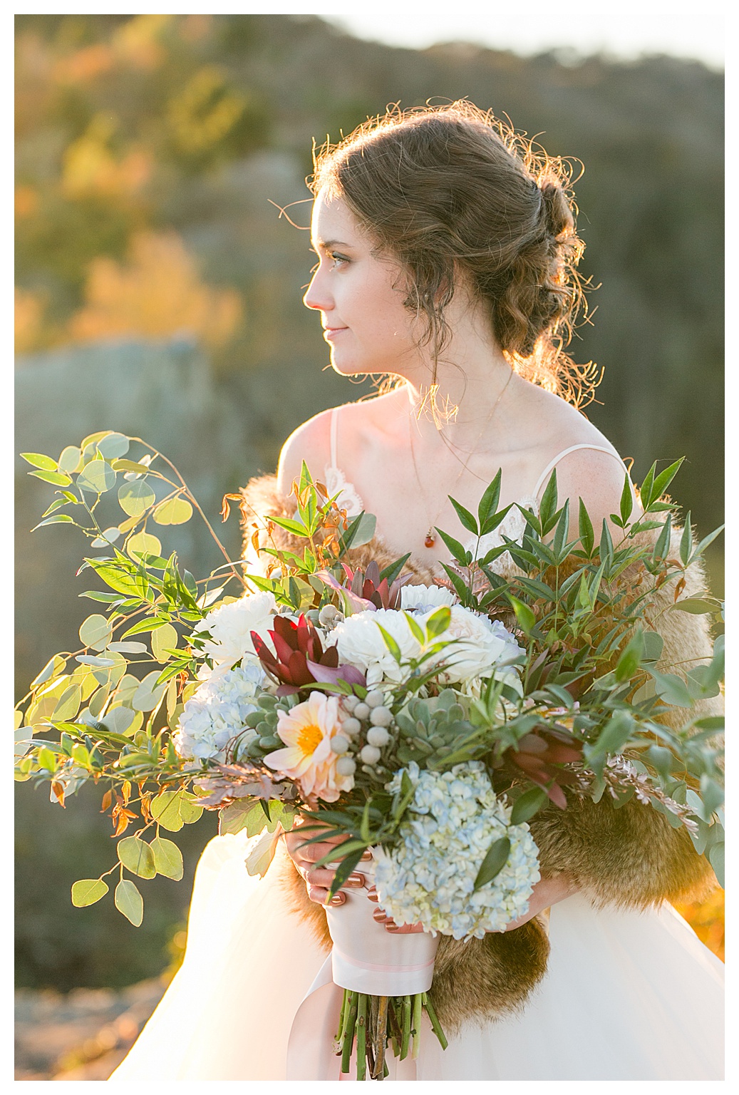bride looks out in the distance as sun sets behind her