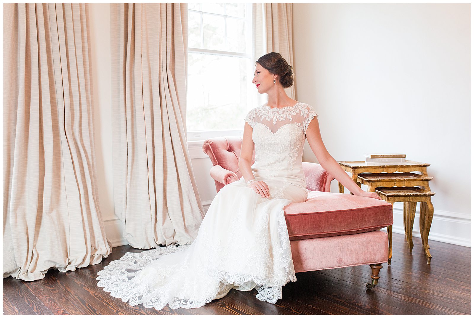 bride poses on blush pink setee during bridal session