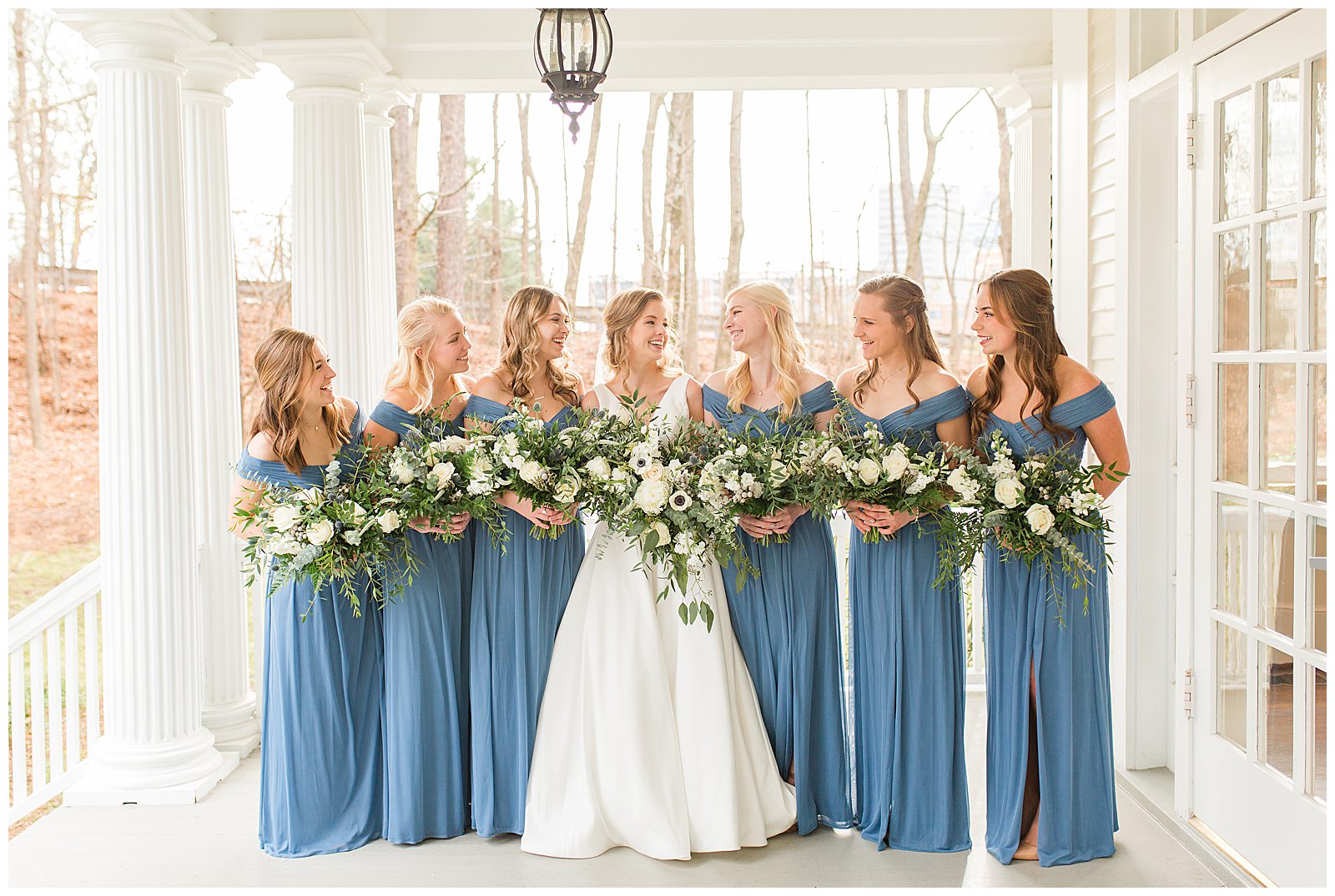 bridesmaids on front porch giggle and look at each other