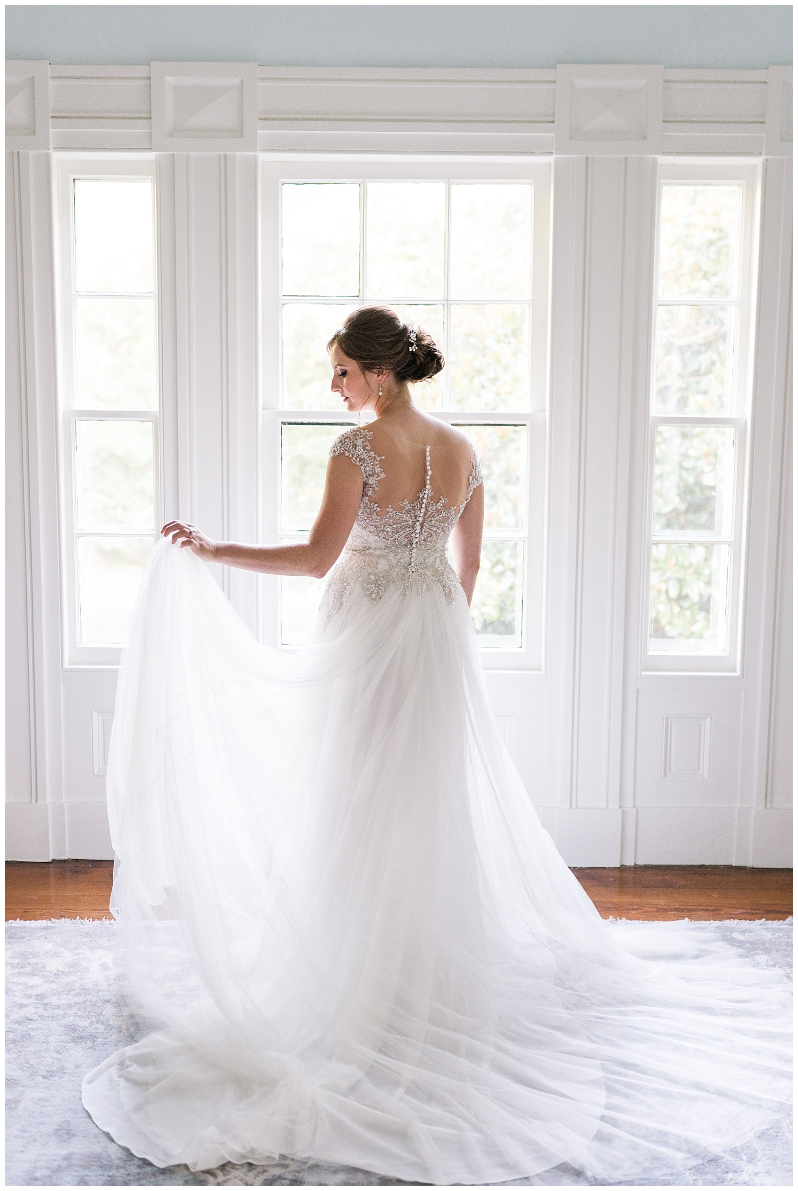back of lace button up bridal gown in styled portrait session by bridal suite windows of historic wedding venue