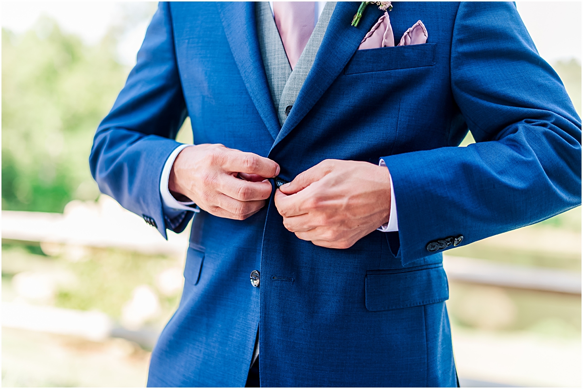Shot of Koy buttoning his Jacket
