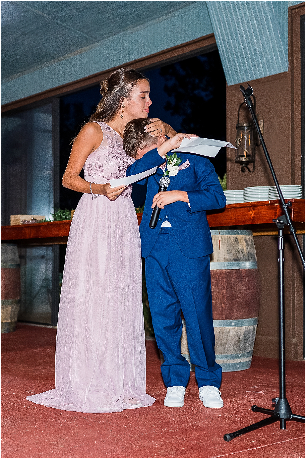 Koy's daughter holding his son as he cries during his speech