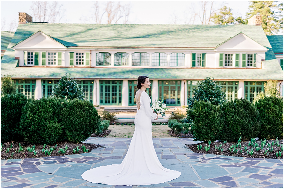 Bridal portrait of a bride with a modern winter gown in front of the Reynolda House Museum in Winston-Salem, NC