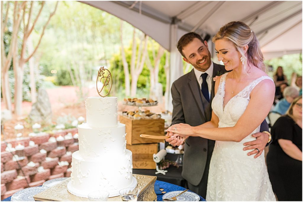 Amber and Chase cutting the cake during their Greensboro wedding