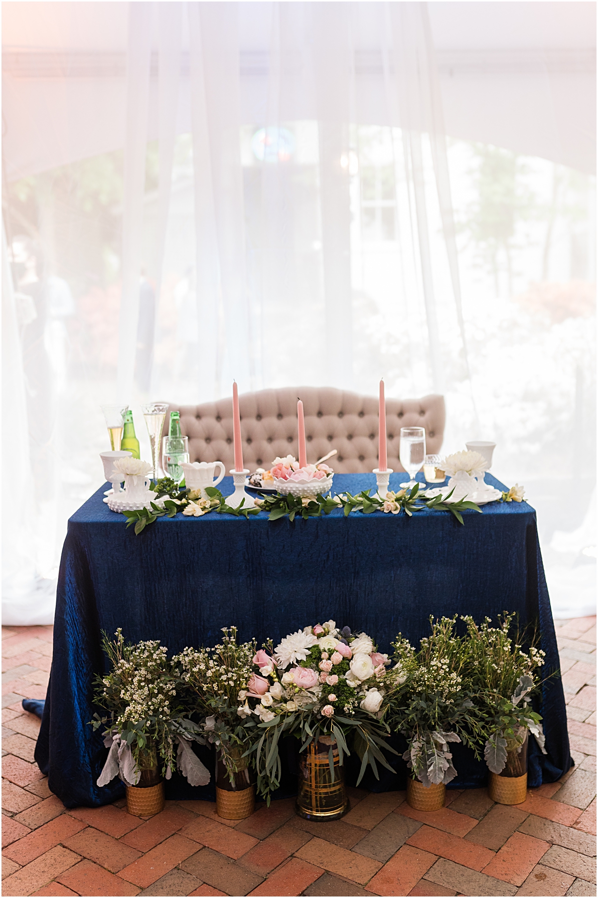 A couch in front of a small table during their Greensboro wedding