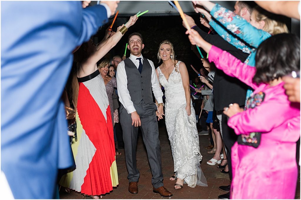 Bride and Groom exiting with a glow stick exit during their Greensboro wedding