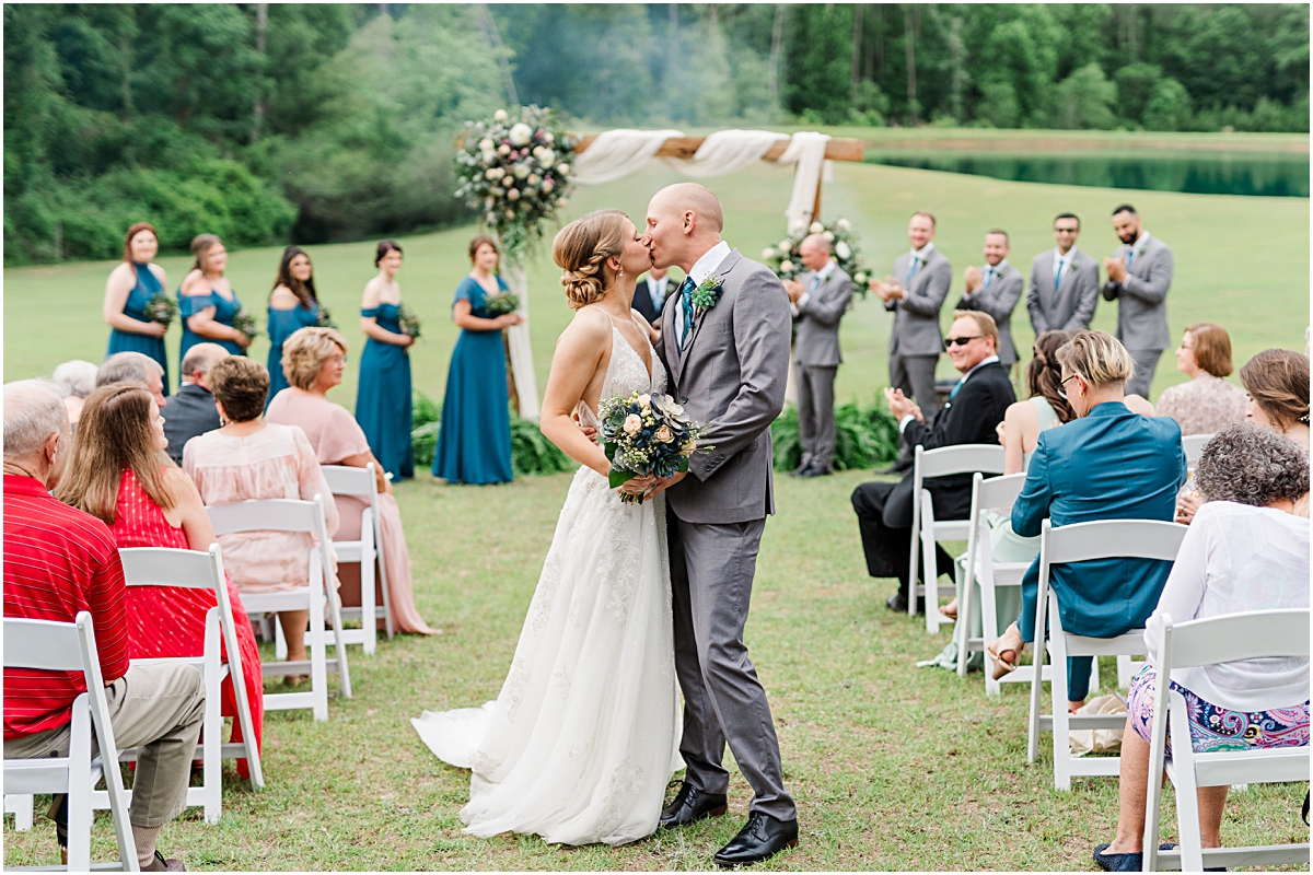 Luke and Brynn share a kiss at the end of the aisle after getting married at a historic home wedding in Georgia