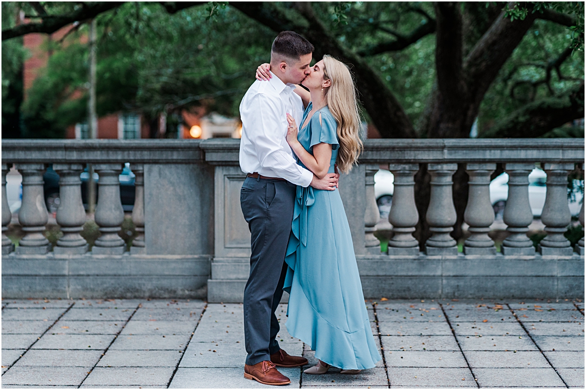 Couple embraces and kisses during their engagement session with a professional Greensboro wedding photographer.