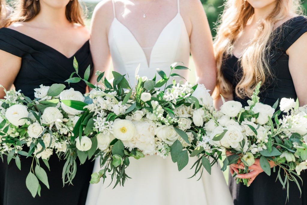 Close up of the white flower bouquets with greenery being held by Haley and her bridesmaids.