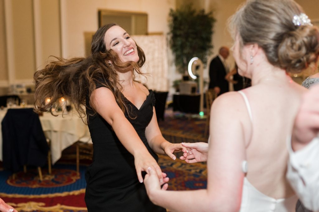 The bride dancing with a guest at her wedding in Raleigh, NC.