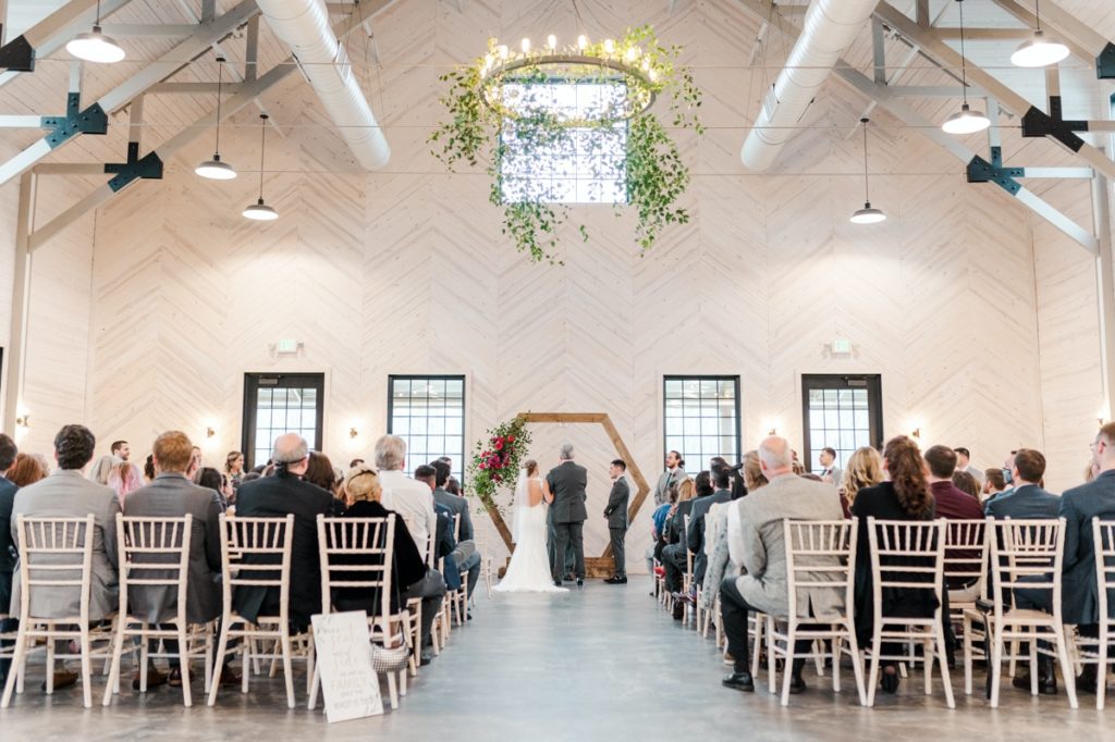 Bride and Groom stand at hexagon arbor during wedding ceremony in spacious event venue Board and Batten in Lexington, NC.