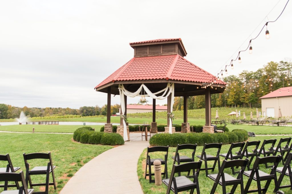 Gazebo with drapery and chairs lined up, decorated and ready for a ceremony at Childress Vineyards Wedding Venue in Lexington, NC.
