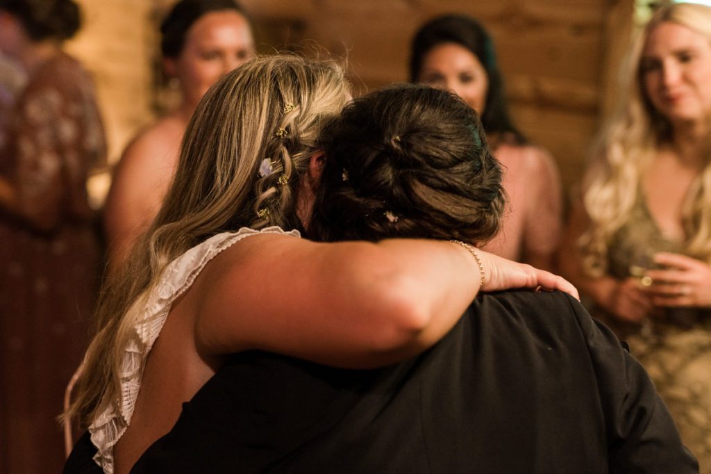 The bride hugging her friend on her wedding day.