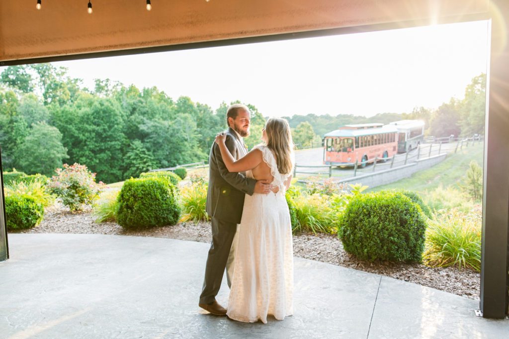 The bride and groom during their first dance with the trolley in the background.