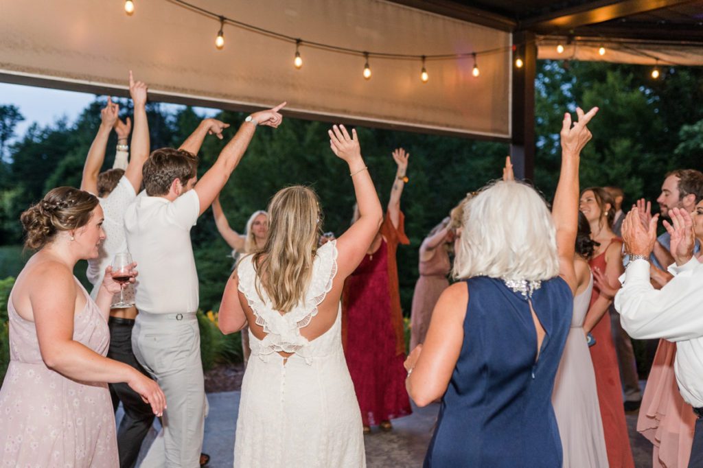 Guests and the bride dancing during a wedding reception at Medaloni Cellars