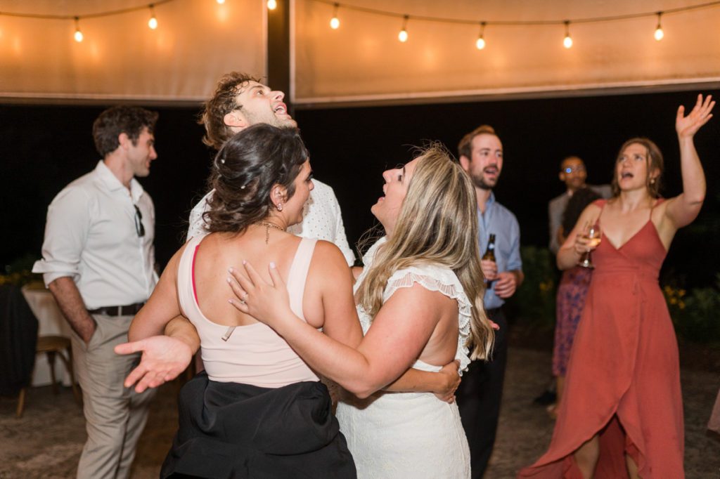 Guests and the bride dancing and singing during a wedding reception at Medaloni Cellars