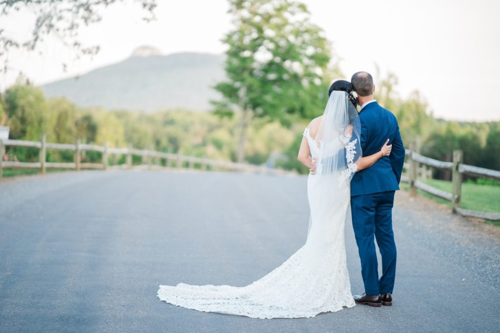 A man and woman facing away from the camera looking off in the distance on their wedding day designed by Charming Carolinas, a Triad Wedding Planner