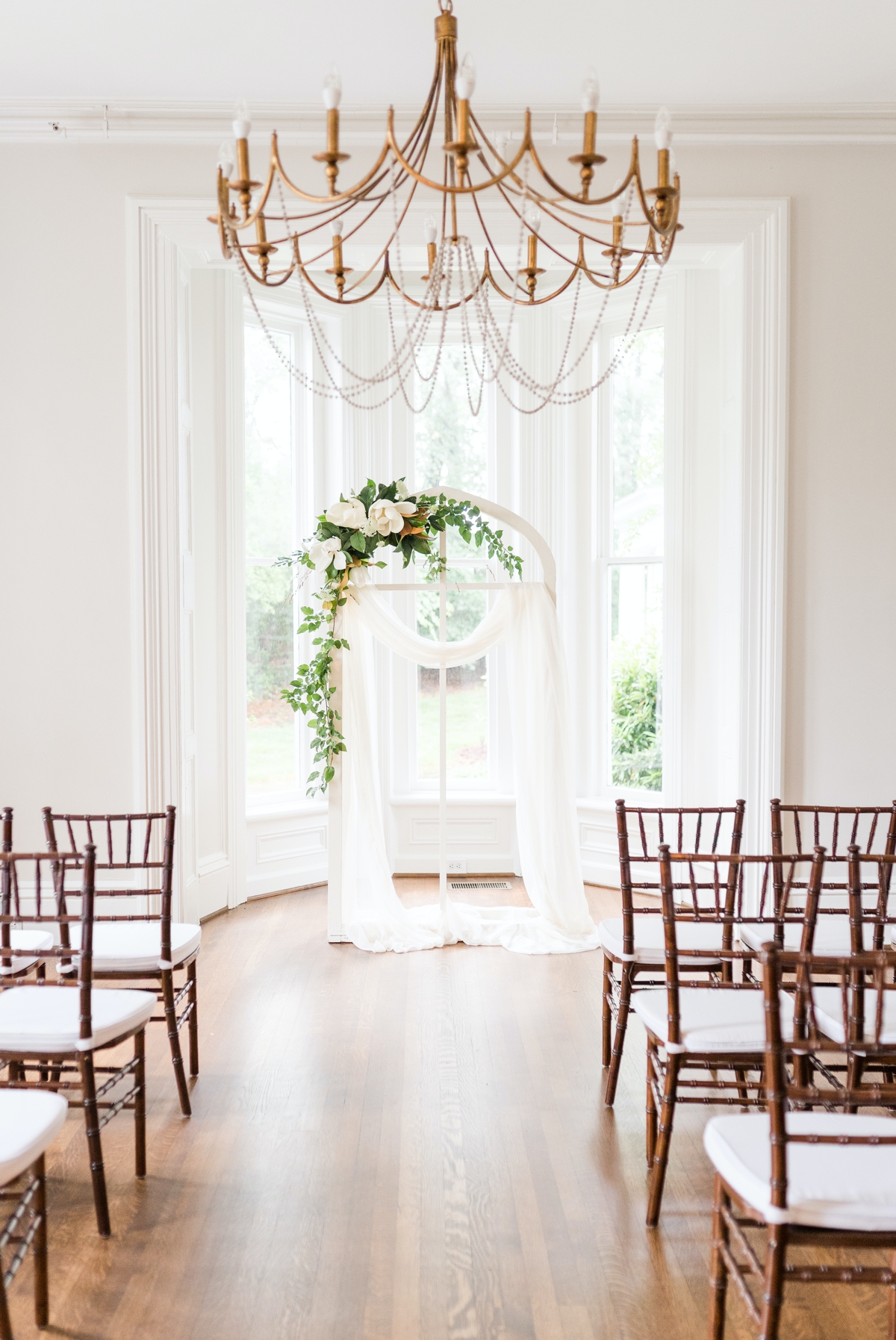 Detail photo of a bright white wedding ceremony arch at McAlister Leftwich House.