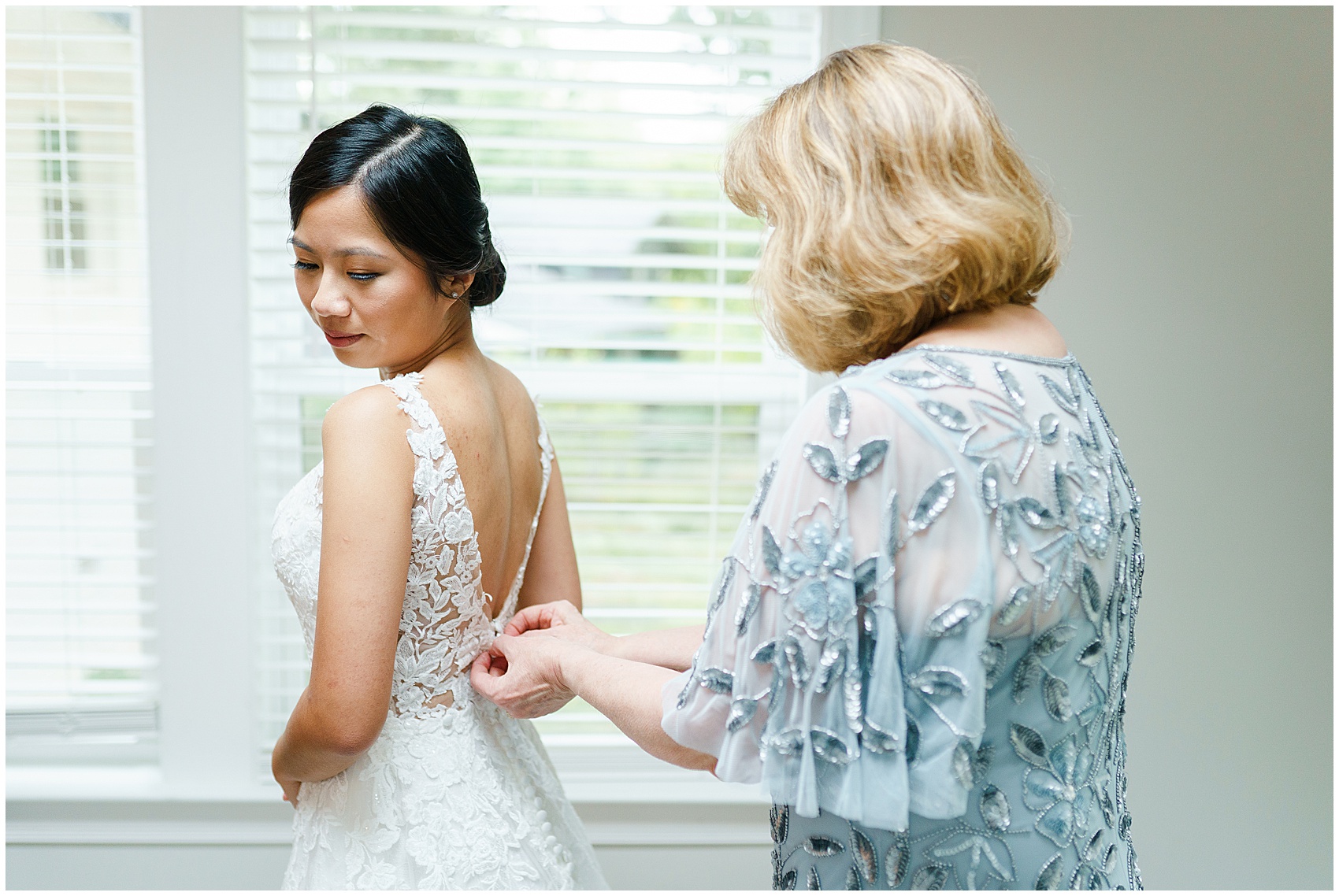 mom zipping up bride's dress at her A Stunning and Historic Leslie Alford Mims House Wedding