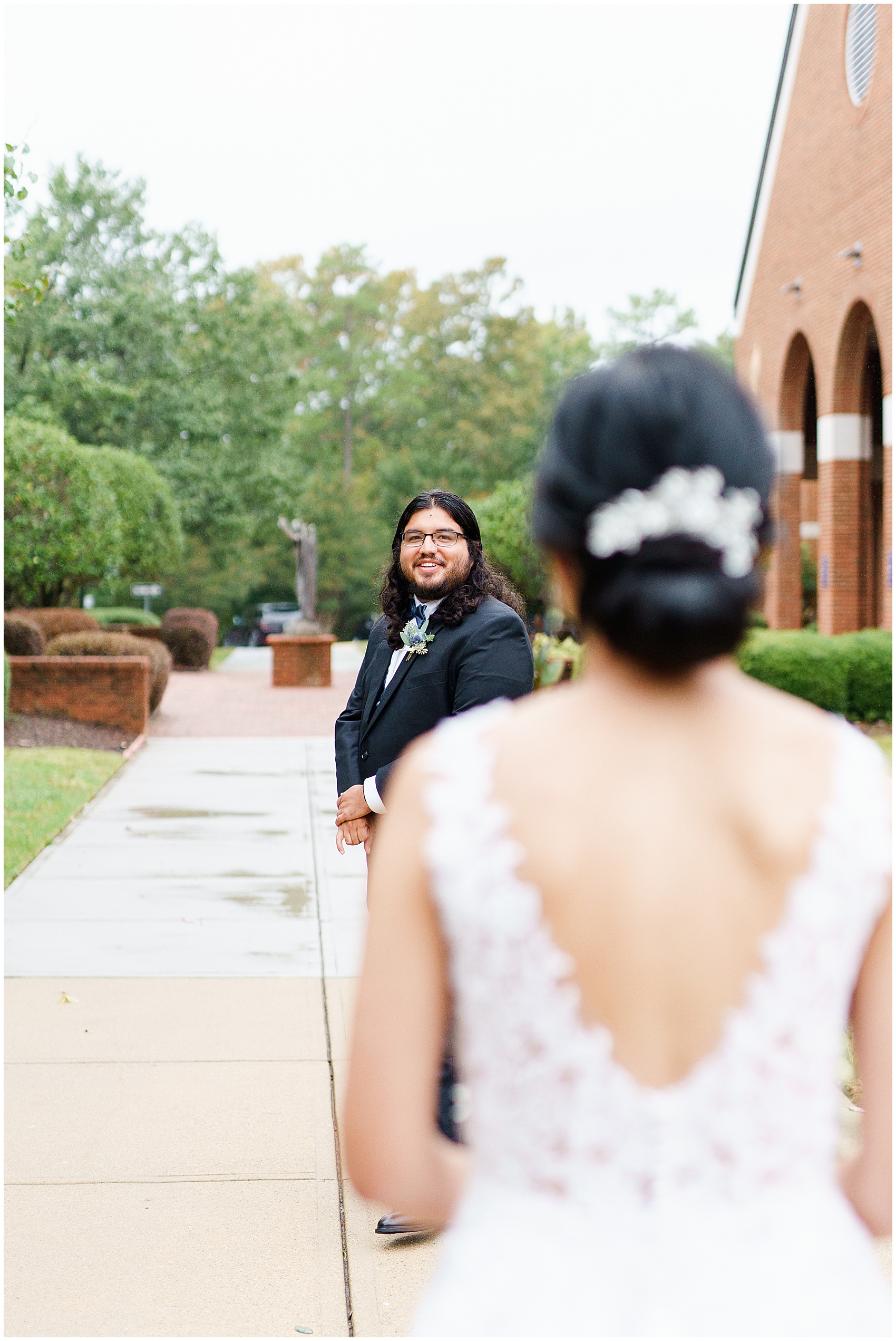 groom smiling while seeing his bride for the first time at their A Stunning and Historic Leslie Alford Mims House Wedding