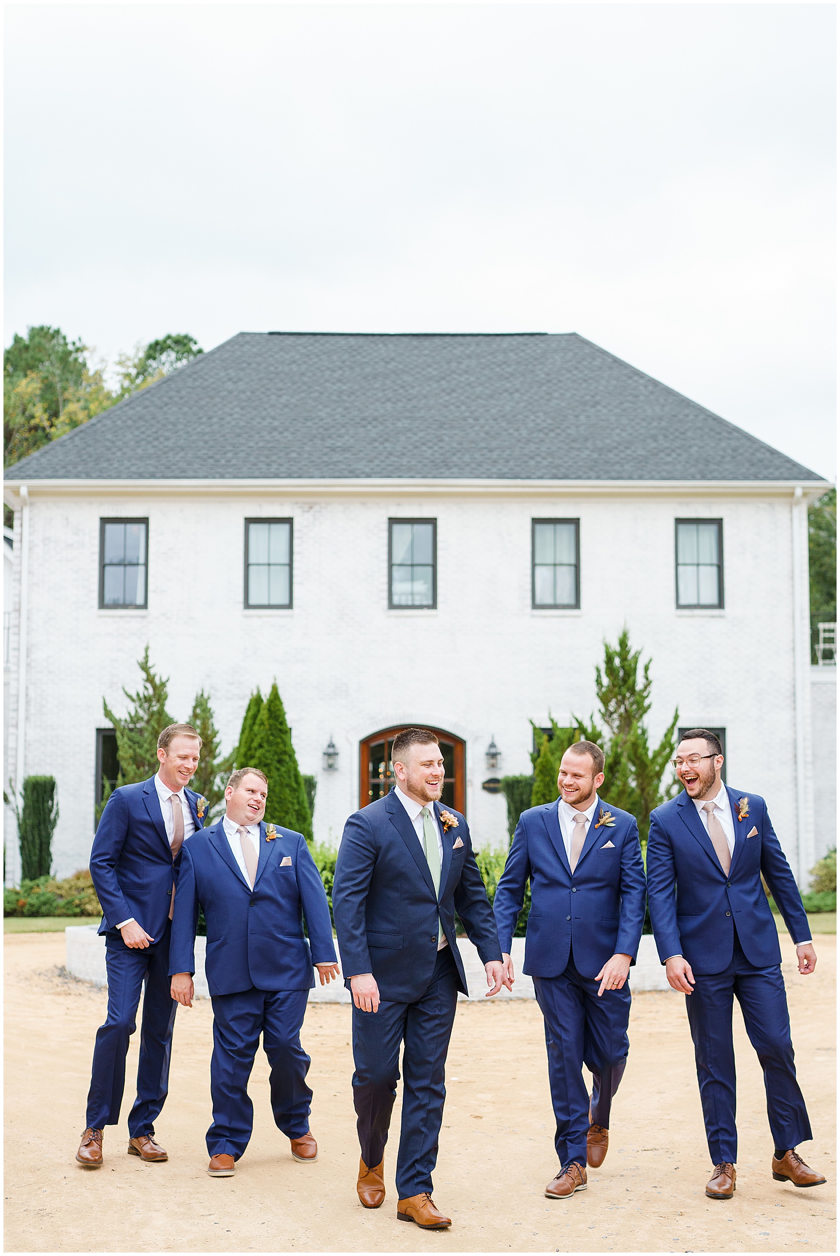 groom and his groomsmen laughing outside